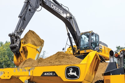 John Deere 350 P-Tier excavator dumping sand in Deere dump truck bed