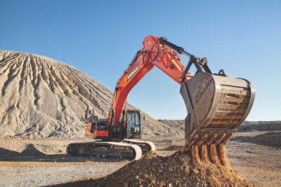 Doosan DX350-7 excavator emptying bucket of dirt in quarry