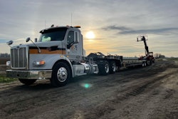 Telehandler parked next to a semi truck
