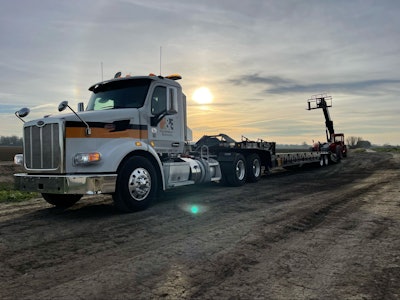 Telehandler parked next to a semi truck