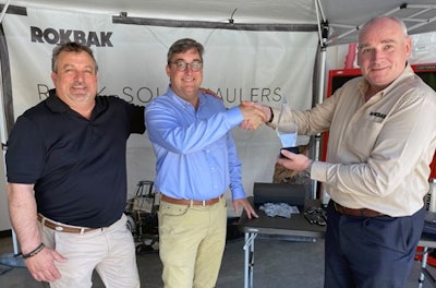 Hills Machinery representatives accept a dealer of the year award from Rokbak