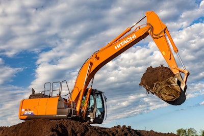 Hitachi ZX210LC-6 excavator with bucketful of dirt raised