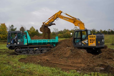 Kato HD514MR-7 excavator on dirt pile dumping dirt in back of crawler carrier