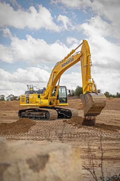 Komatsu PC360LCi-11 excavator unloading dirt