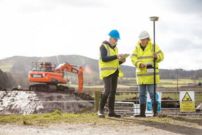 A survey crew using a rover with a smart antenna that uses visual positioning to map points on a construction site.