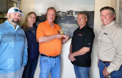 Shafer Equipment Company representatives accept a dealer of the year award from Rokbak