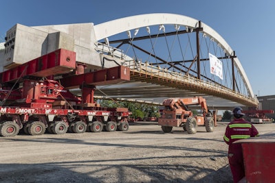 Second Avenue Bridge over I-94 Detroit being moved into place by self-propelled modular transporters