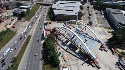 Second Avenue Bridge over I-94 Detroit being moved into place by self-propelled modular transporters