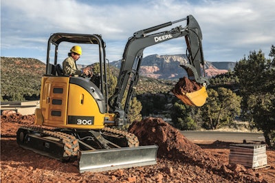 John Deere 30G compact excavator digging at a building site.