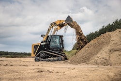 ASV RT-75HD compact track loader dumping dirt from bucket onto dirt pile