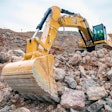 Cat 350 excavator with arm extended toward camera.