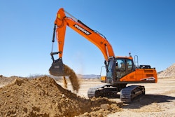 Doosan DX225LC-7 digging in a pile of dirt