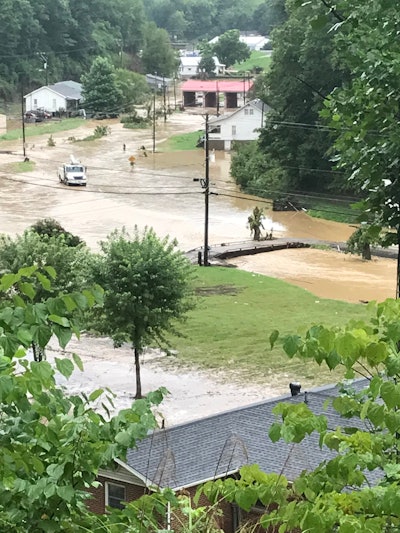Kentucky floods KY 550 flooded Knott County brown water over roads around homes