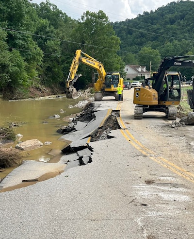 kentucky floods Komatsu and Deere excavators work to clean a Clay County road damaged by mudslide