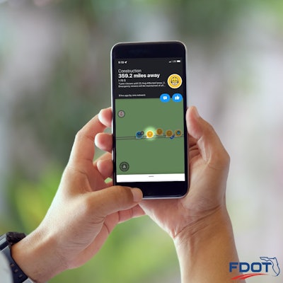 Florida new Lane Closure Notification System for work zone safety app staged photo of two hands holding smartphone showing navigation app display