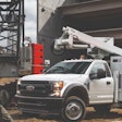 Ford F-550 Super Duty Hydrogen Fuel Cell Electric Truck SoCalGas white utility truck in front of building under construction man in hardhat reflective vest walking in front