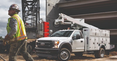 Ford F-550 Super Duty Hydrogen Fuel Cell Electric Truck SoCalGas white utility truck in front of building under construction man in hardhat reflective vest walking in front