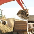 Excavator loading a dump truck with dirt