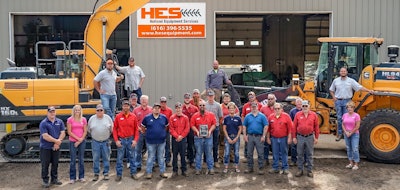 Holland Equipment Services employees standing in front of Hyundai Construction Equipment