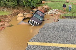 Mississippi road washout pickup truck falls in sitting in muddy water beneath destroyed SR 489 Newton County
