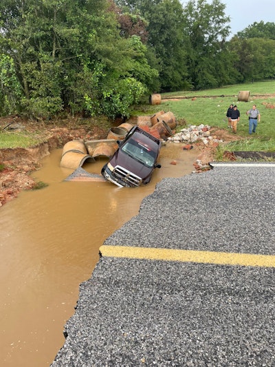 Mississippi road washout pickup truck falls in sitting in muddy water beneath destroyed SR 489 Newton County