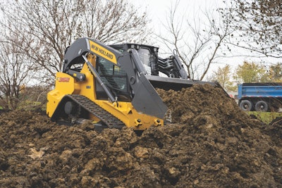 New Holland C362 compact track loader in dark earth pile pushing dirt
