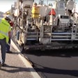 Paver and crew lay rubberized asphalt made with recycled tires
