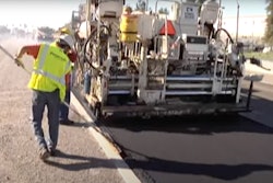 Paver and crew lay rubberized asphalt made with recycled tires
