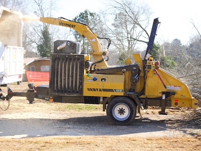 Vermeer AX17 brush chipper throws debris into a trailer