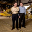 Dan and Thom Reynolds pose in front of Kobelco excavators