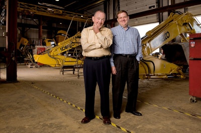 Dan and Thom Reynolds pose in front of Kobelco excavators