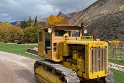 1940 Caterpillar D6 crawler tractor wooden cab restored parked on driveway in front of mountains