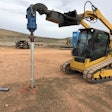 Caterpillar compact track loader installing a helical pier