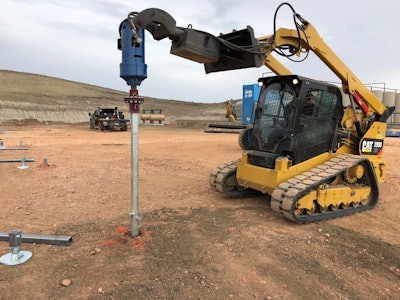 Caterpillar compact track loader installing a helical pier