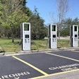 electric vehicle charging stations lined up in parking lot stock photo