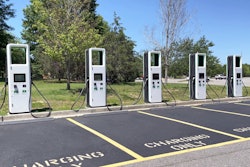 electric vehicle charging stations lined up in parking lot stock photo