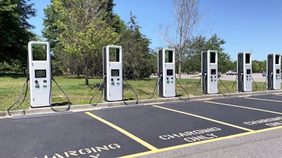 electric vehicle charging stations lined up in parking lot stock photo