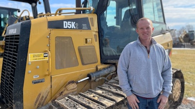 Eric Watson, Watson Excavating next to a Caterpillar D5K bulldozer