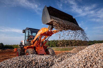 Hitachi ZW100 Wheel loader dumping gravel on rock pile