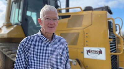 Lynn Watson, Watson Excavating next to a Caterpillar bulldozer