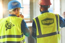Two workers wearing B2W safety vests and hard hats