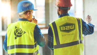 Two workers wearing B2W safety vests and hard hats