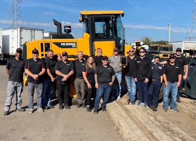 Universal Truck sales team poses with a Hyundai wheel loader
