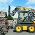 New Holland L220 Skid Steer lifting a pallet of landscaping materials