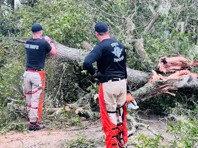 Florida state troopers cut trees that fell during Hurricane Ian in Tampa Florida