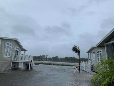 hurricane ian road between two houses flooded Flagler County