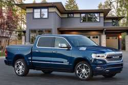 2023 Ram 1500 Limited Elite blue parked in front of house