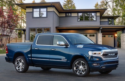2023 Ram 1500 Limited Elite blue parked in front of house