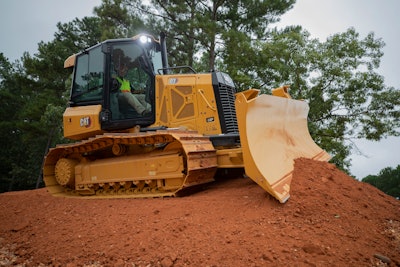 Cat D3 dozer on top of dirt pile