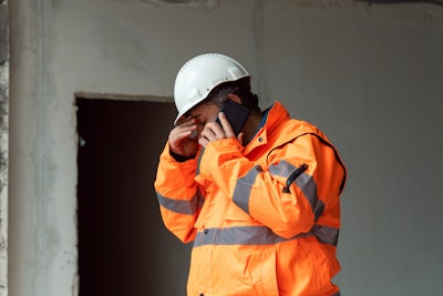 Upset contractor talking on the phone